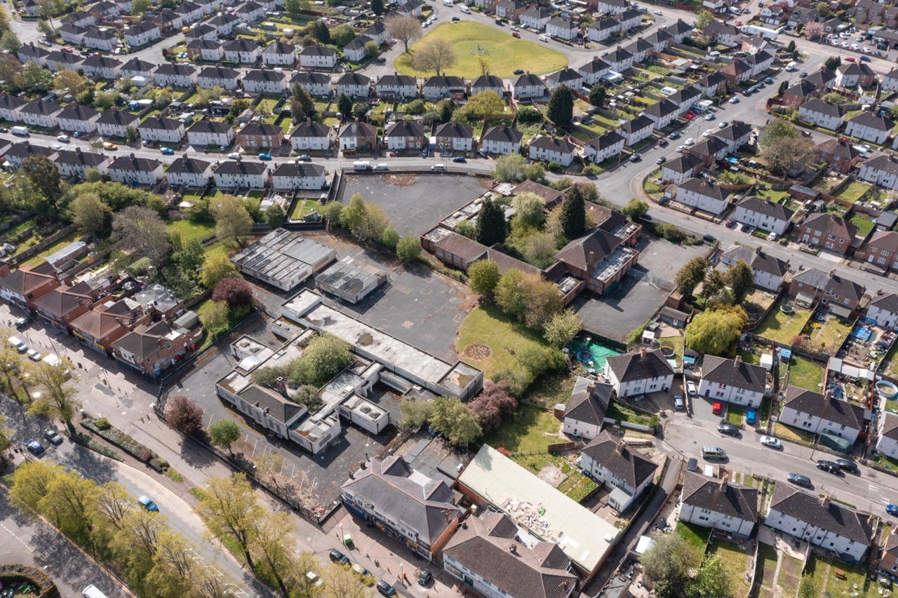 This image: an aerial photo of the site from above Southfields
					Drive looking south. The map: The map has zoomed into the site, with
					labels over the former Southfields School and the former Newry School.
					There are six blue camera icons around the perimeter of the site,
					which, when clicked on, show streetview photos of the site from
					Southfields Drive, the Newry and Schoolgate.
